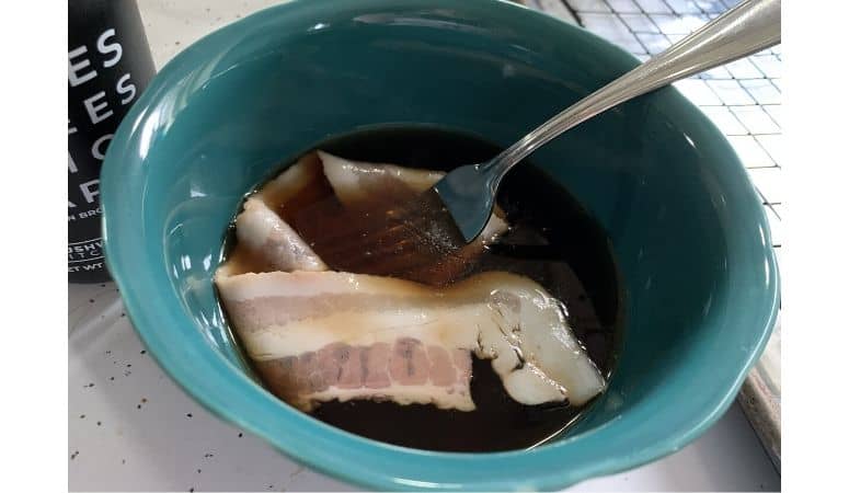 bacon in a syrup and brown sugar mixture